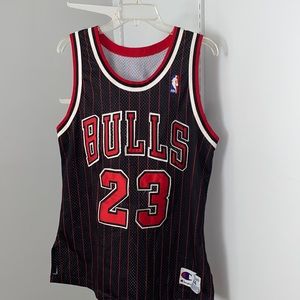 Bulls Jersey #23 worn by Michael Jordan. With black background and white piping.